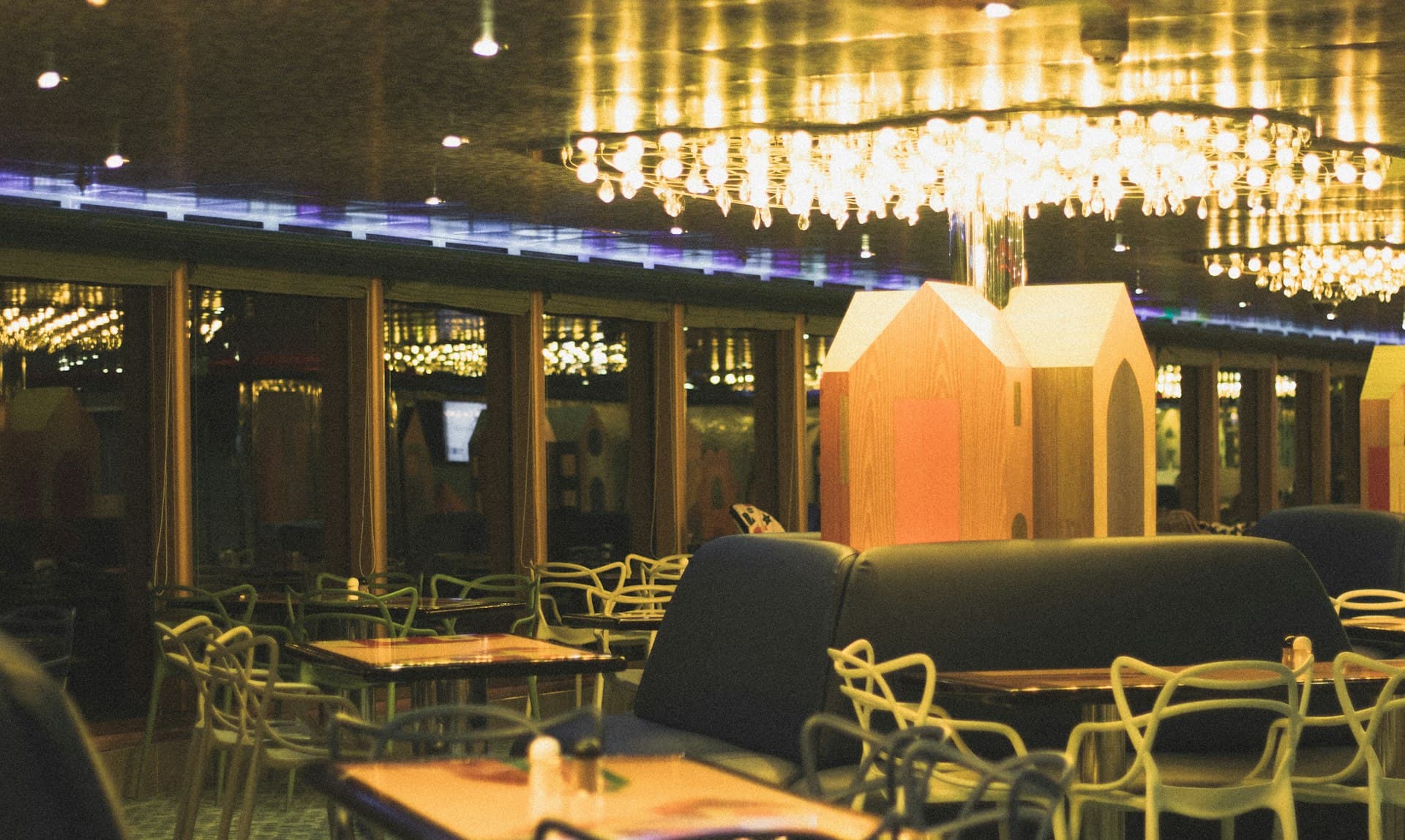 A warm, candlelit restaurant dining room glowing in the evening