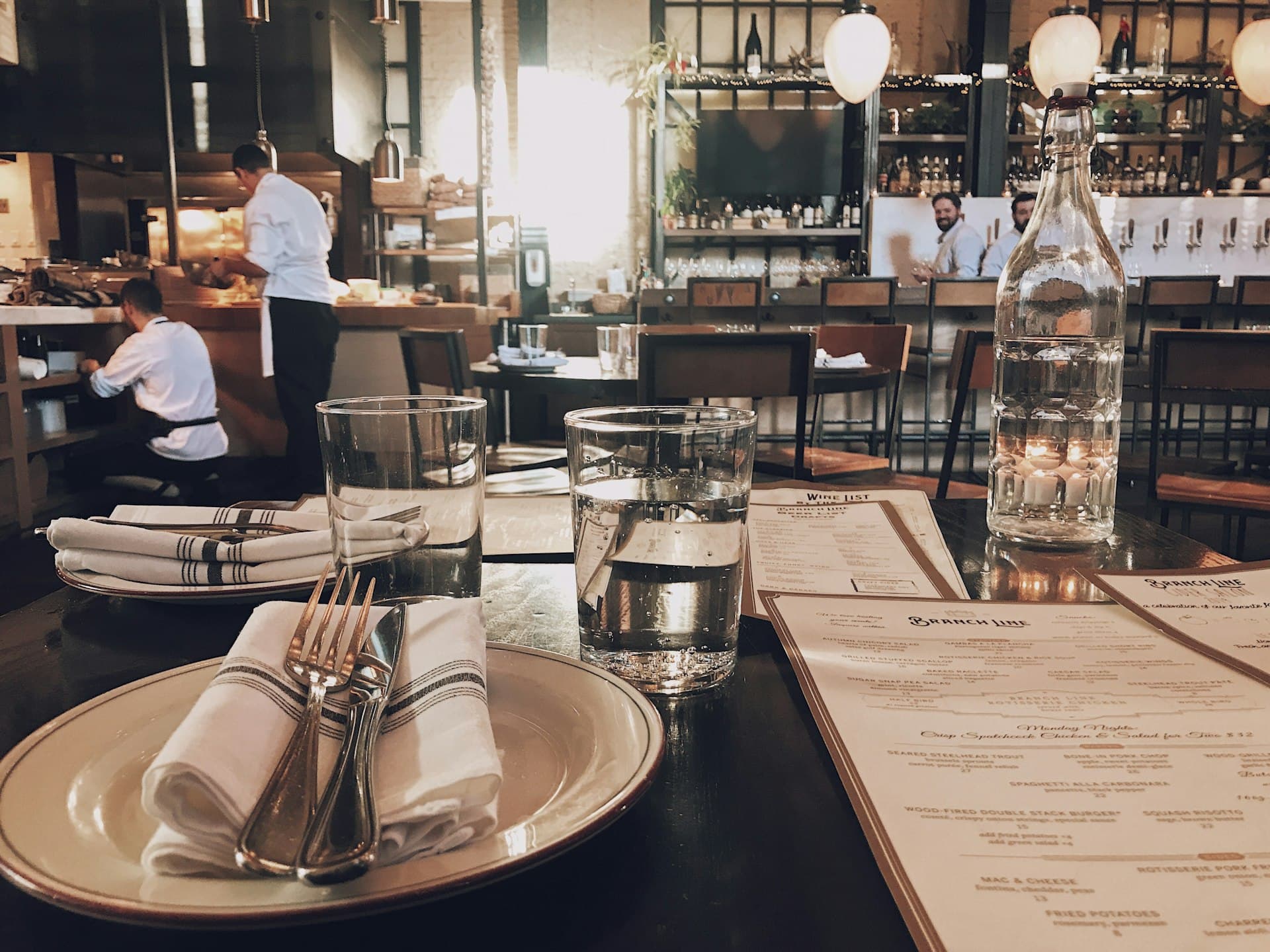 A single elegant place setting at a warm restaurant table
